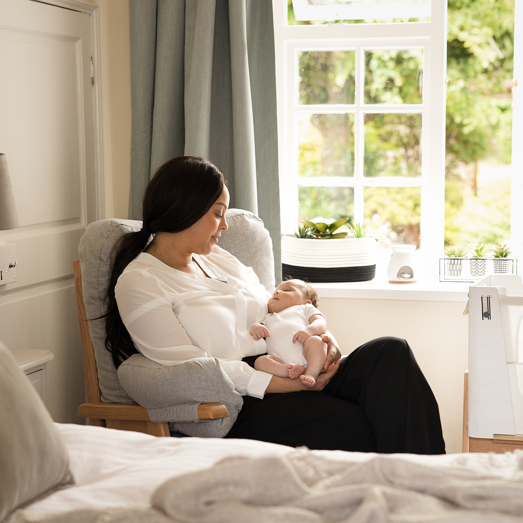 Gaia Baby Hera rocking and nursing chair, mum holding baby in chair.