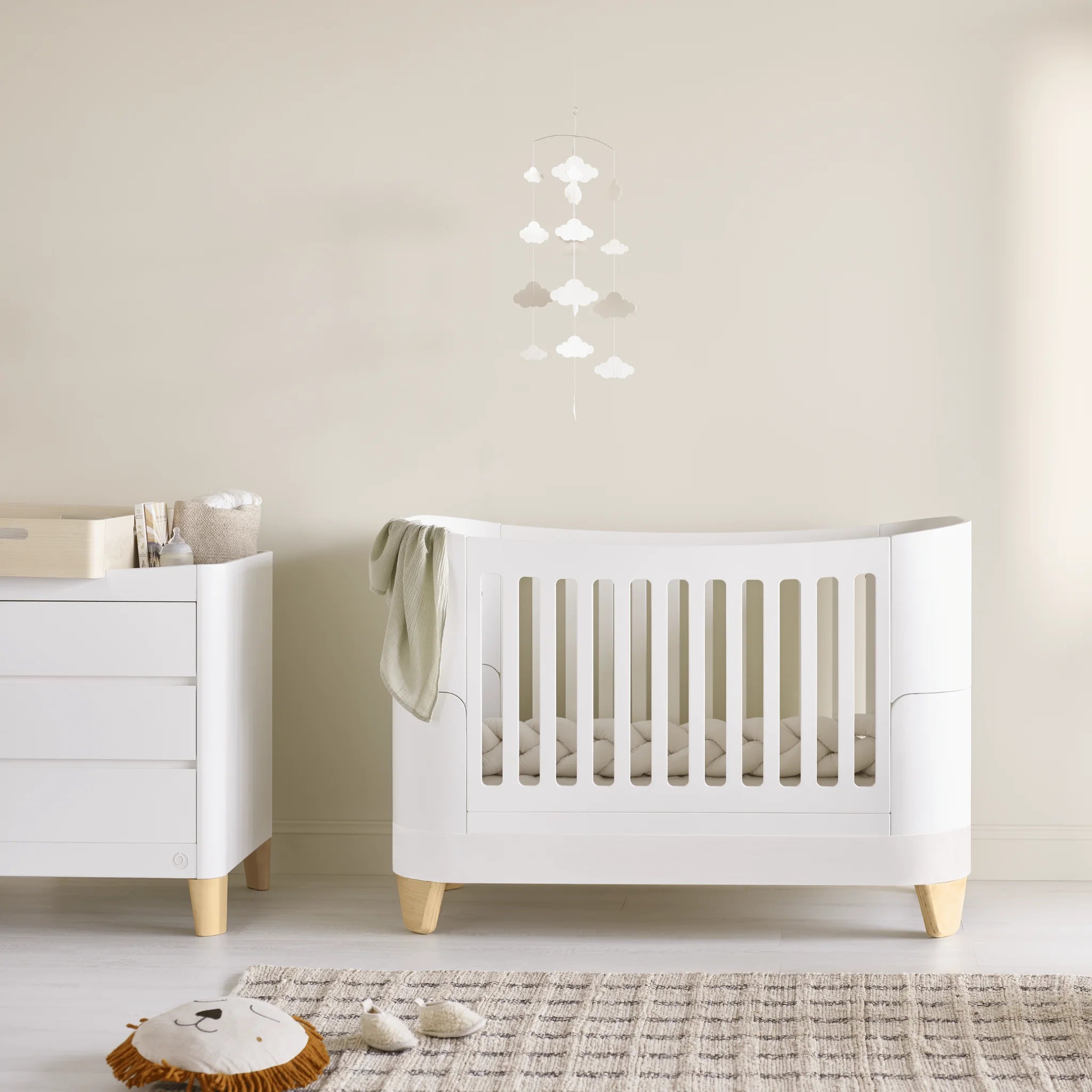 Minimalist nursery featuring the Gaia Baby Serena Cot Bed and Serena Dresser with natural wood legs, styled with the Hera Changing Station, soft neutral décor, and calming Scandinavian-inspired design.
