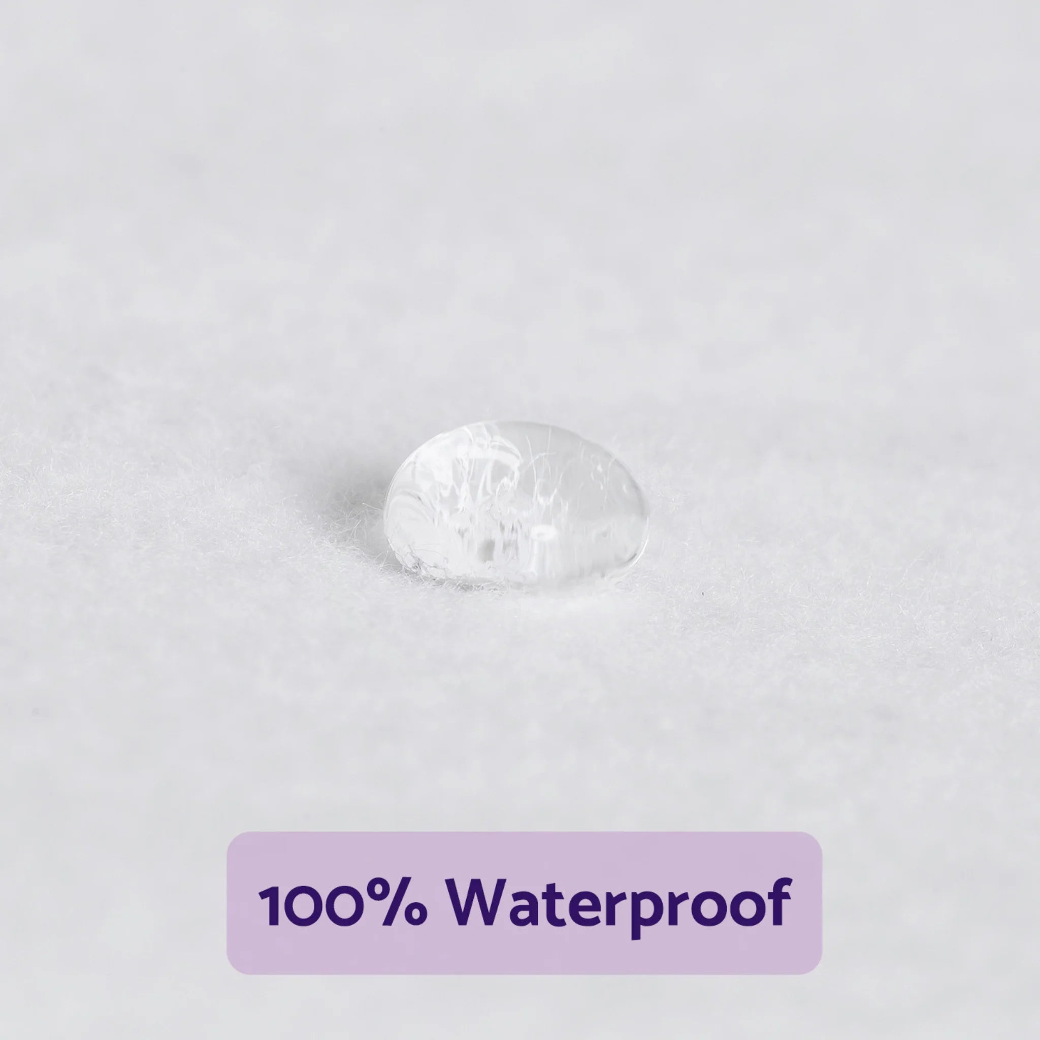 Water droplet beading on ClevaMama waterproof mattress protector fabric showing liquid resistance