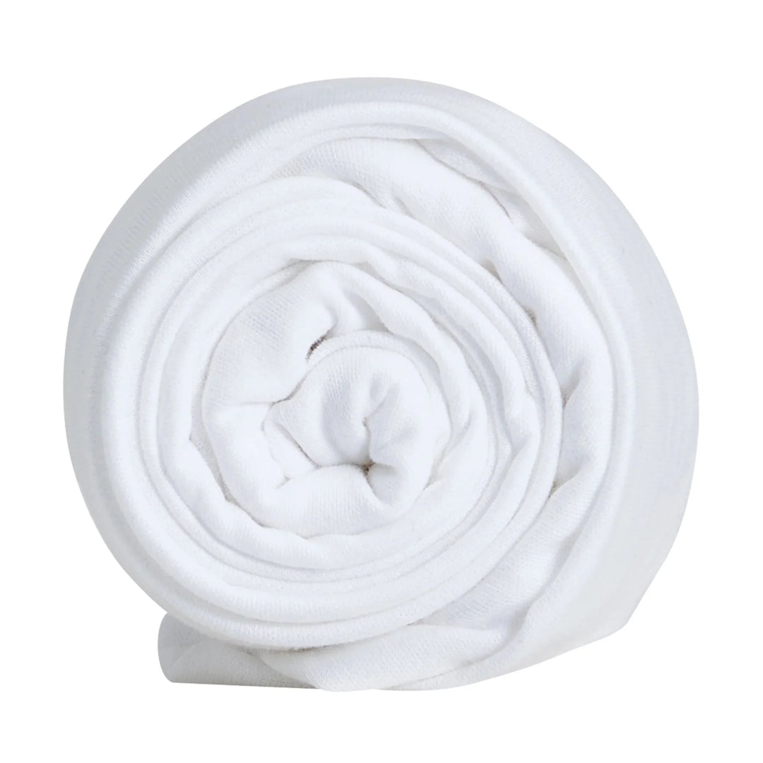 Hera bedside crib fitted sheet rolled up.