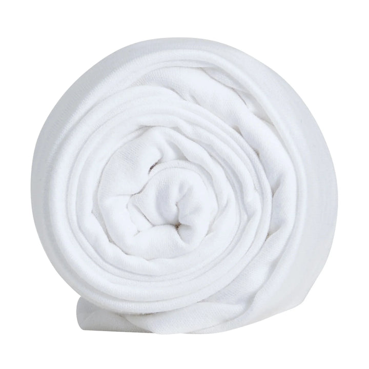 Hera bedside crib fitted sheet rolled up.