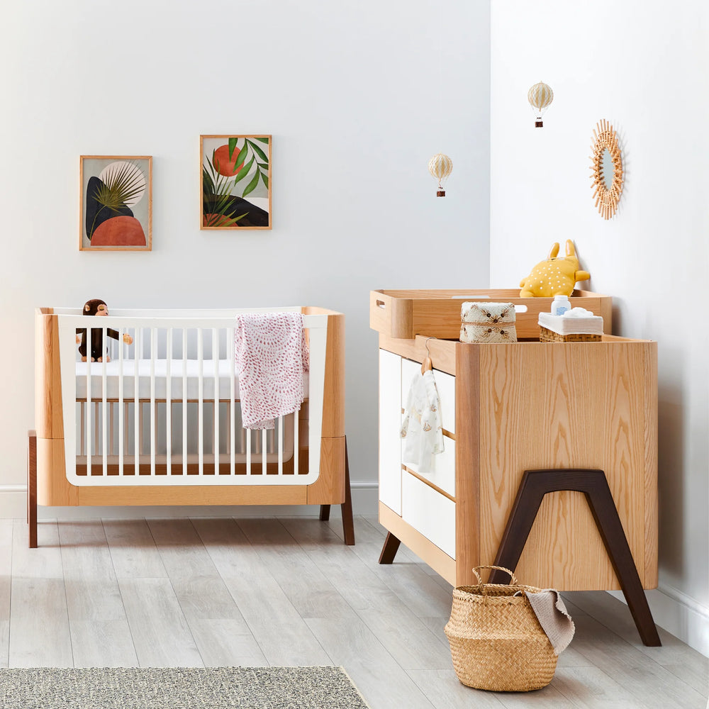 Hera Cot Bed with matching dresser in Natural Ash | Walnut in nursery.