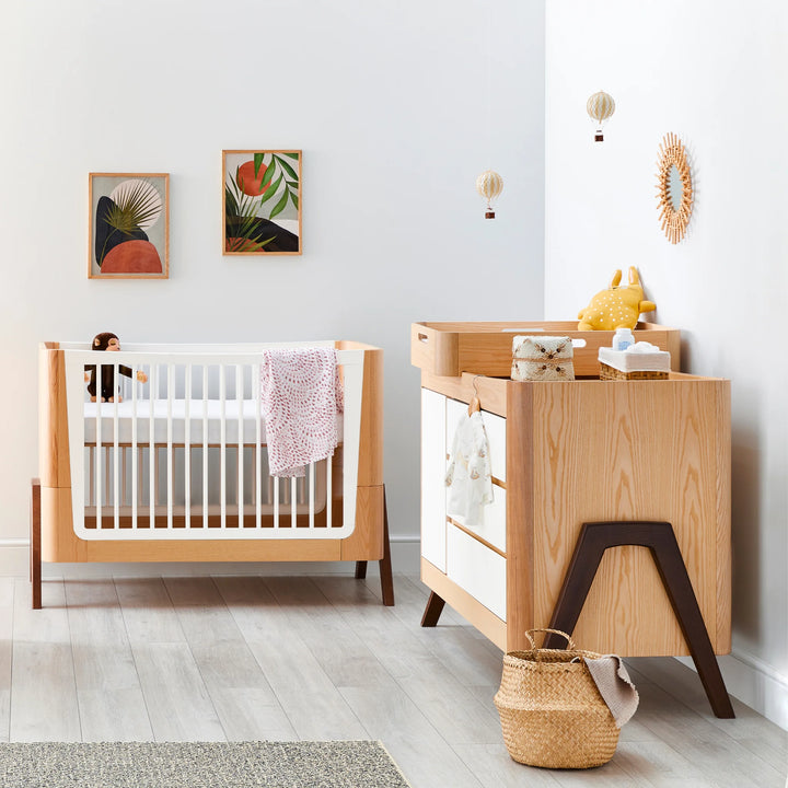 Hera Cot Bed with matching dresser in Natural Ash | Walnut in nursery.