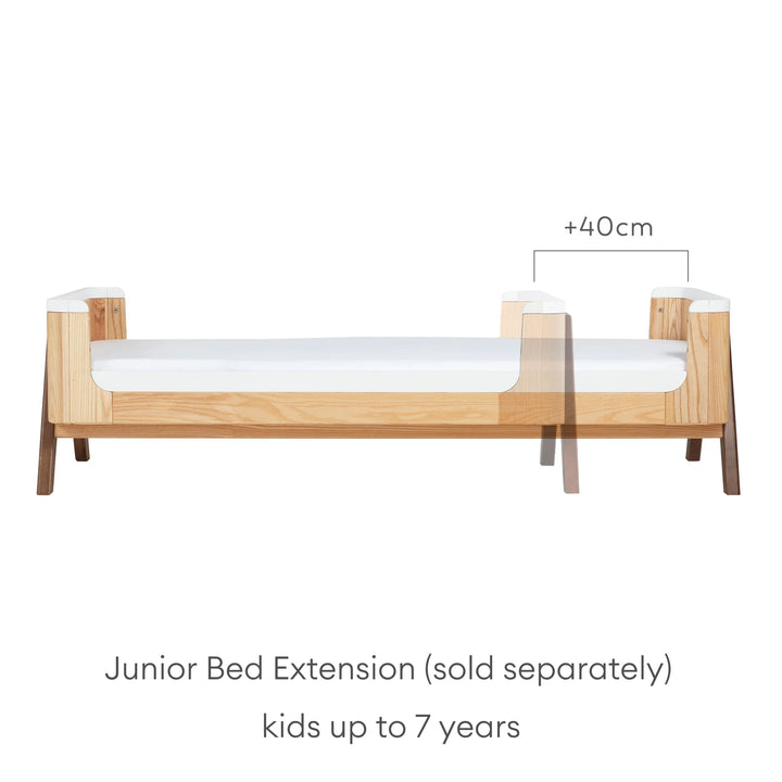 Hera Cot Bed Natural Ash Walnut in first bed mode with additional junior bed extension (sold separately) for children up to 7 years.