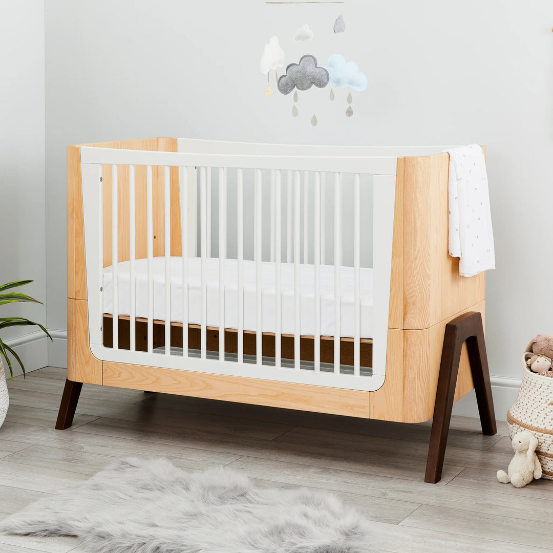 Hera Cot Bed mid-mattress height styled in modern nursery.