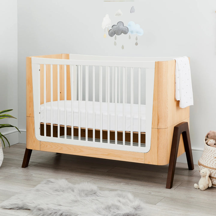 Hera Cot Bed mid-mattress height styled in modern nursery.