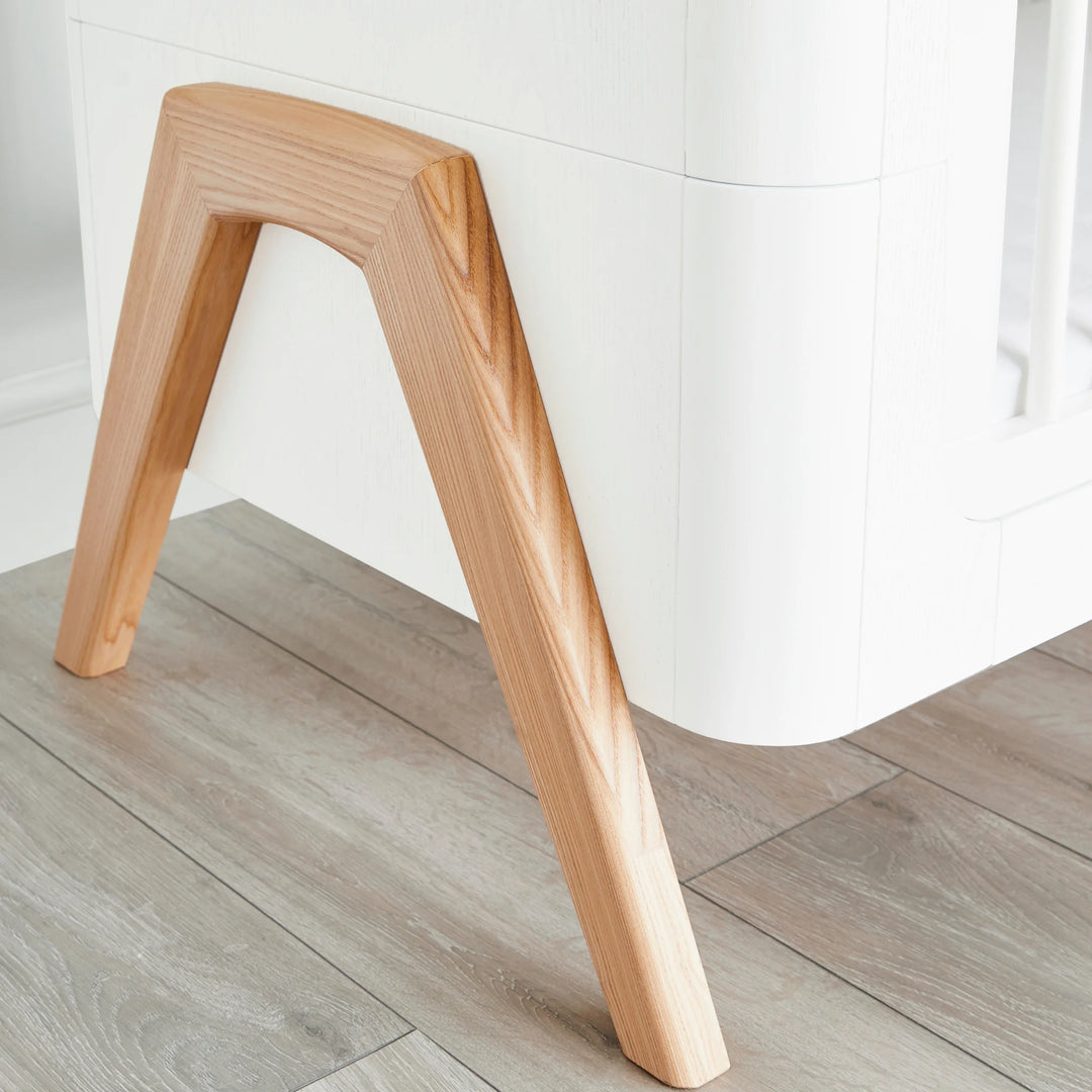 Hera Cot Bed close up of handcrafted wooden A-frame legs.