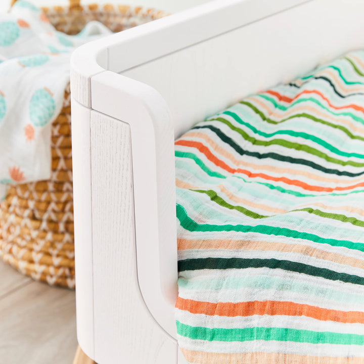 Hera Cot Bed in first bed mode close up of real wood grain.