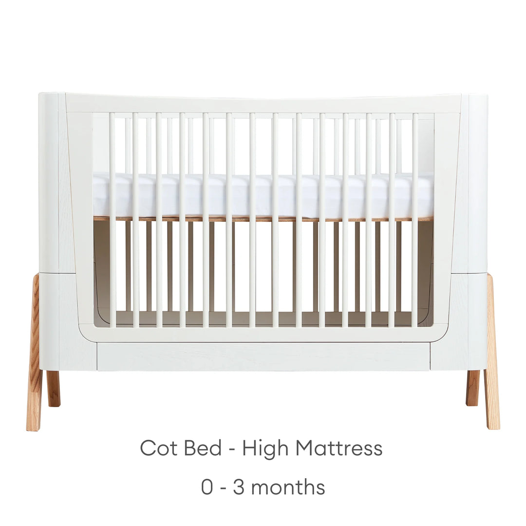 Hera Cot Bed Scandi White front view with high mattress height suitable from birth to three months.