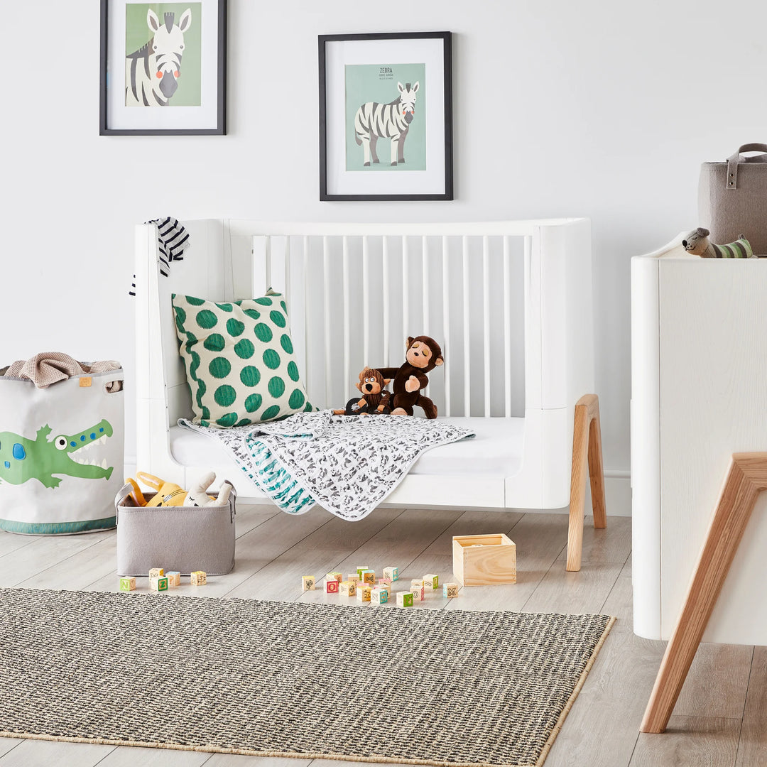 Hera Cot Bed in Toddler Bed mode with teddy bears and soft furnishings.