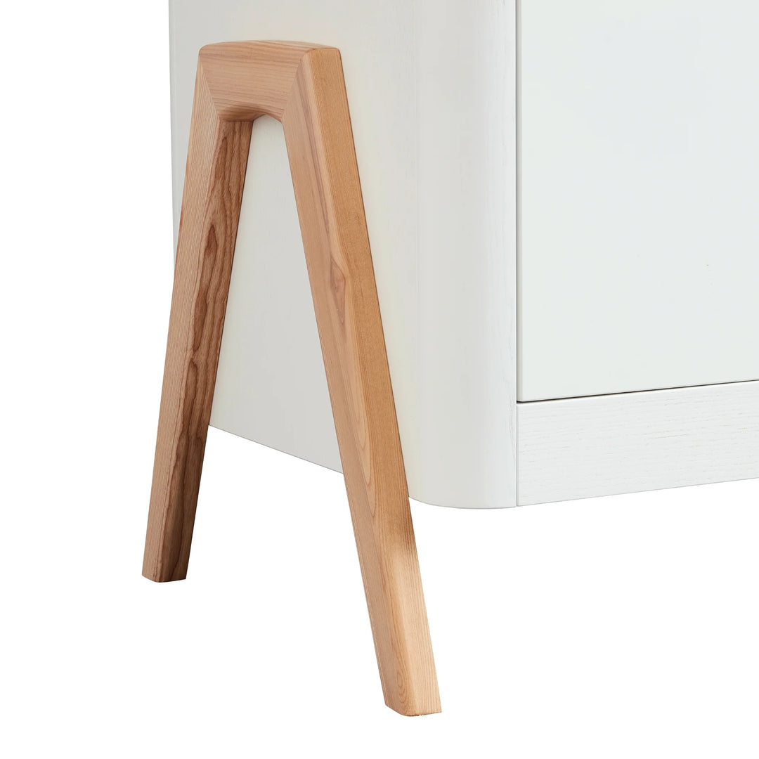 Close up of the real natural wood a-frame legs on the Gaia Baby Hera Dresser in scandi white.