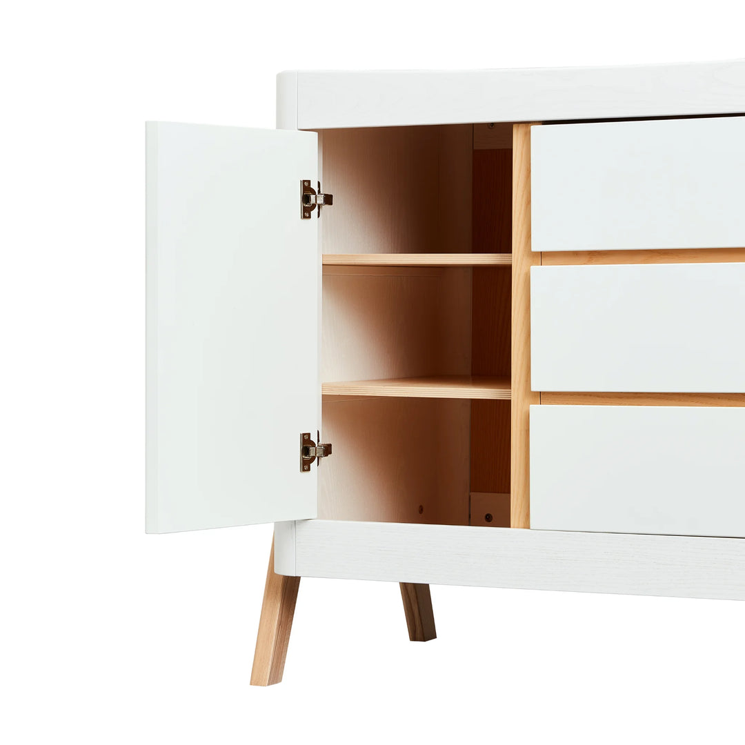Angled view of Gaia Baby Hera Nursery Dresser with cupboard door open showing 2 spacious shelves.