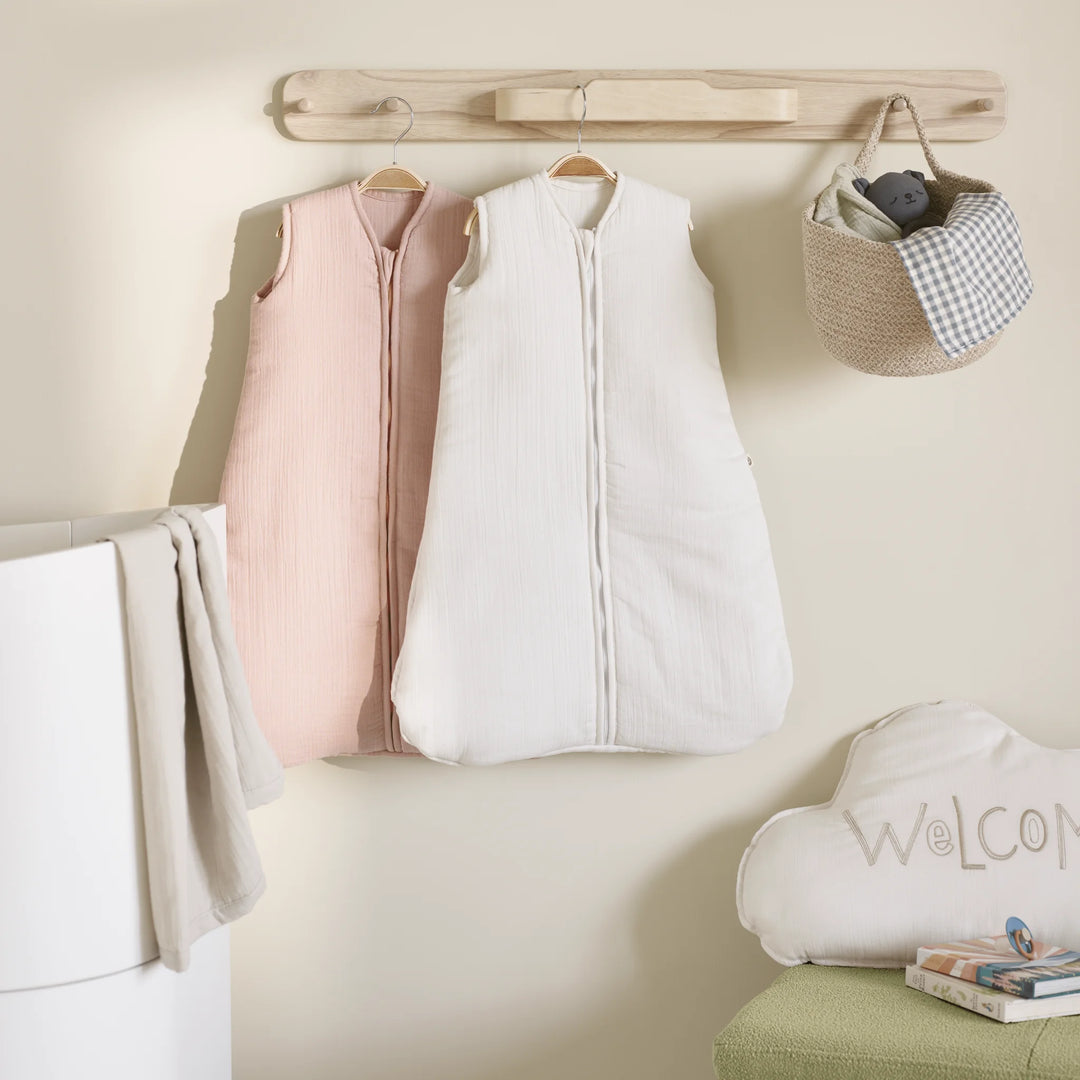 Hera natural hanging rail on nursery wall with sleeping bags hanging off rail.