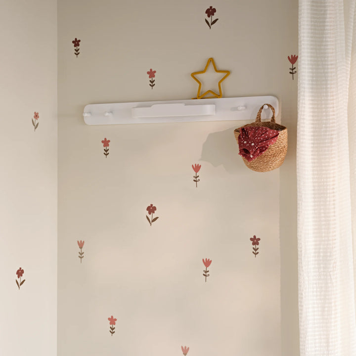 Hera white hanging rail on nursery wall with woven basket hanging on the peg rail.