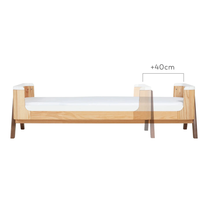 Front view showing the 40cm size increase between Gaia Baby Hera First Bed and Junior Bed in white natural.