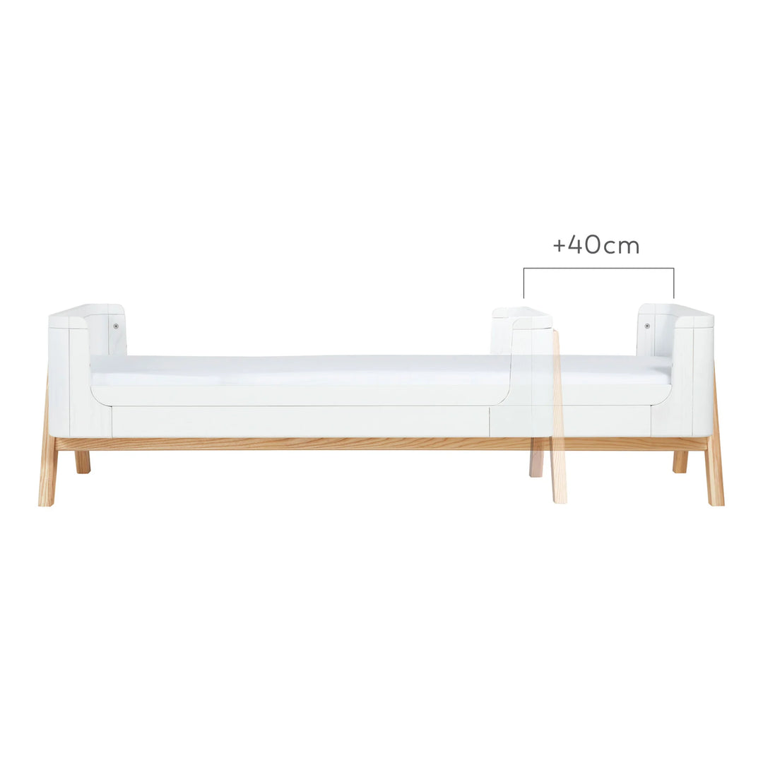 Front view showing the 40cm size increase between Gaia Baby Hera First Bed and Junior Bed in scandi white.