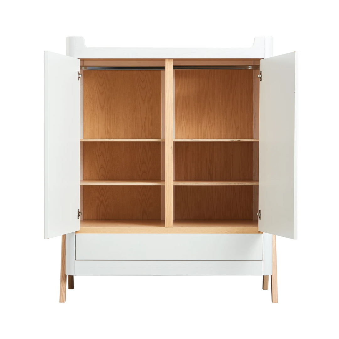 Front view of Gaia Baby Hera Nursery wardrobe in scandi white wood, doors open showing hanging rail and 6 shelves. Below open doors is a full width drawer.