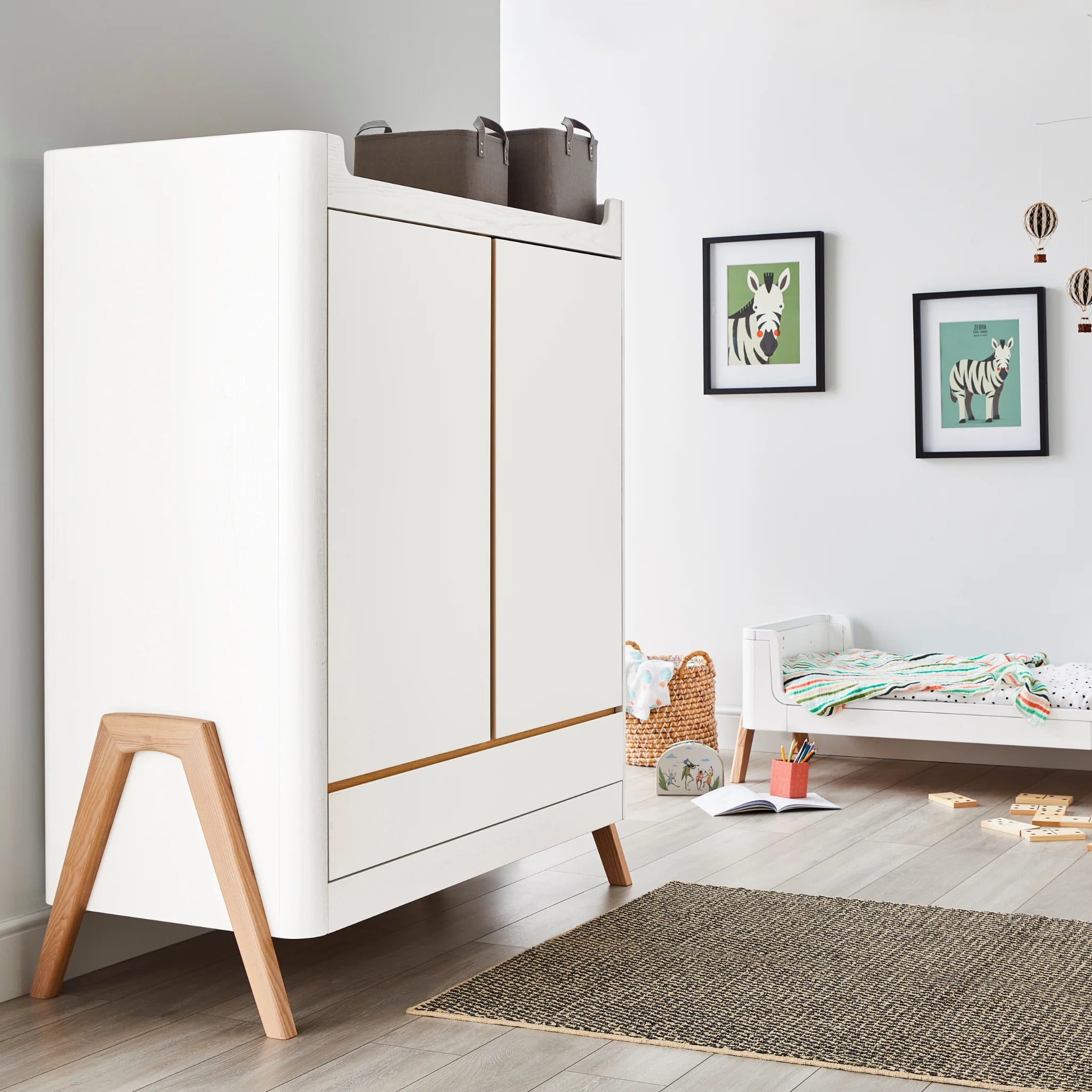 Hera-Kleiderschrank im skandinavisch inspirierten Kinderzimmer mit geschlossenen Türen.