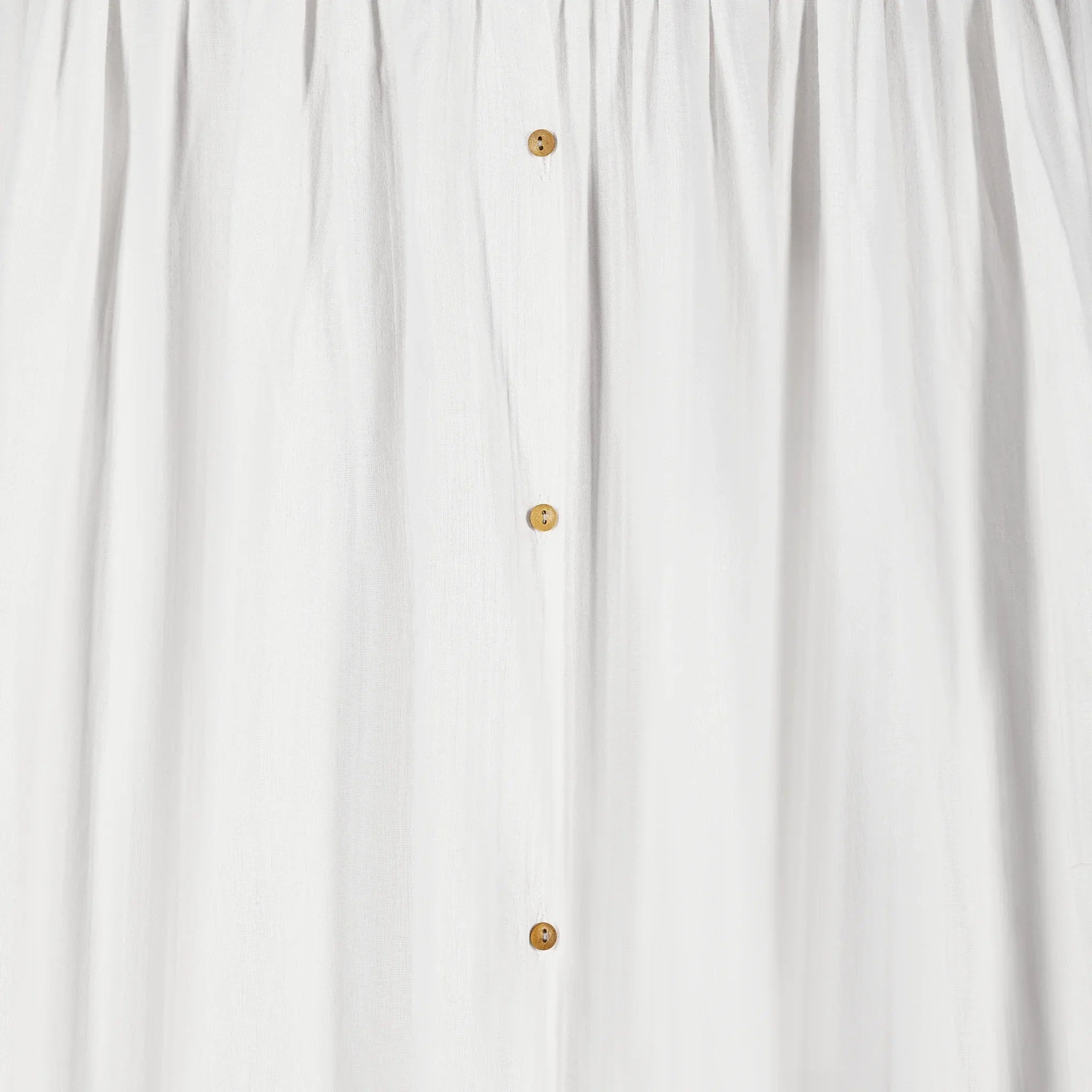 A closeup image of the buttons on Gaia Baby Maia Collection Canopy in white