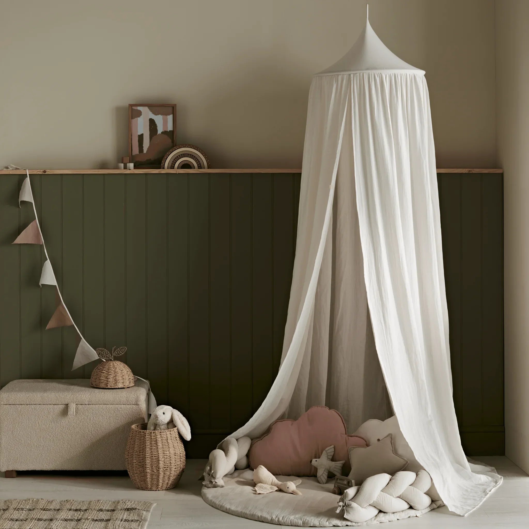 Gaia Baby Maia muslin playmat with braided pillow edge styled under a canopy in a nursery setting