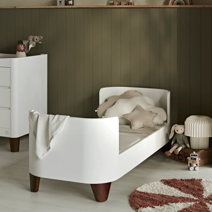 Gaia Baby Serena Cot Bed with walnut wood legs converted to child's first bed in a modern style child's room