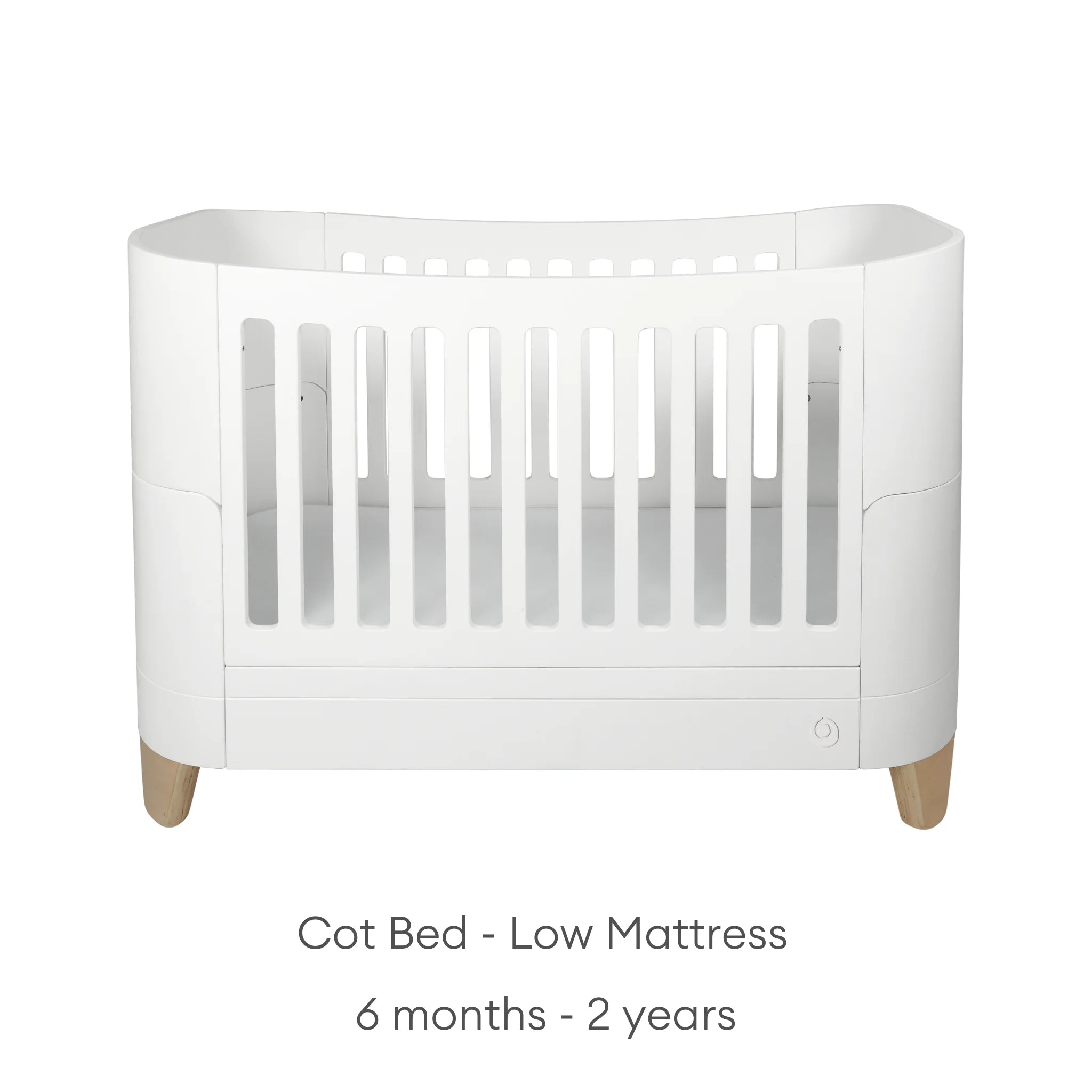 Front view of the white Serena cot bed in low mattress mode for babies and toddlers aged 6 months to 2 years, featuring smooth curved edges and natural wood legs.