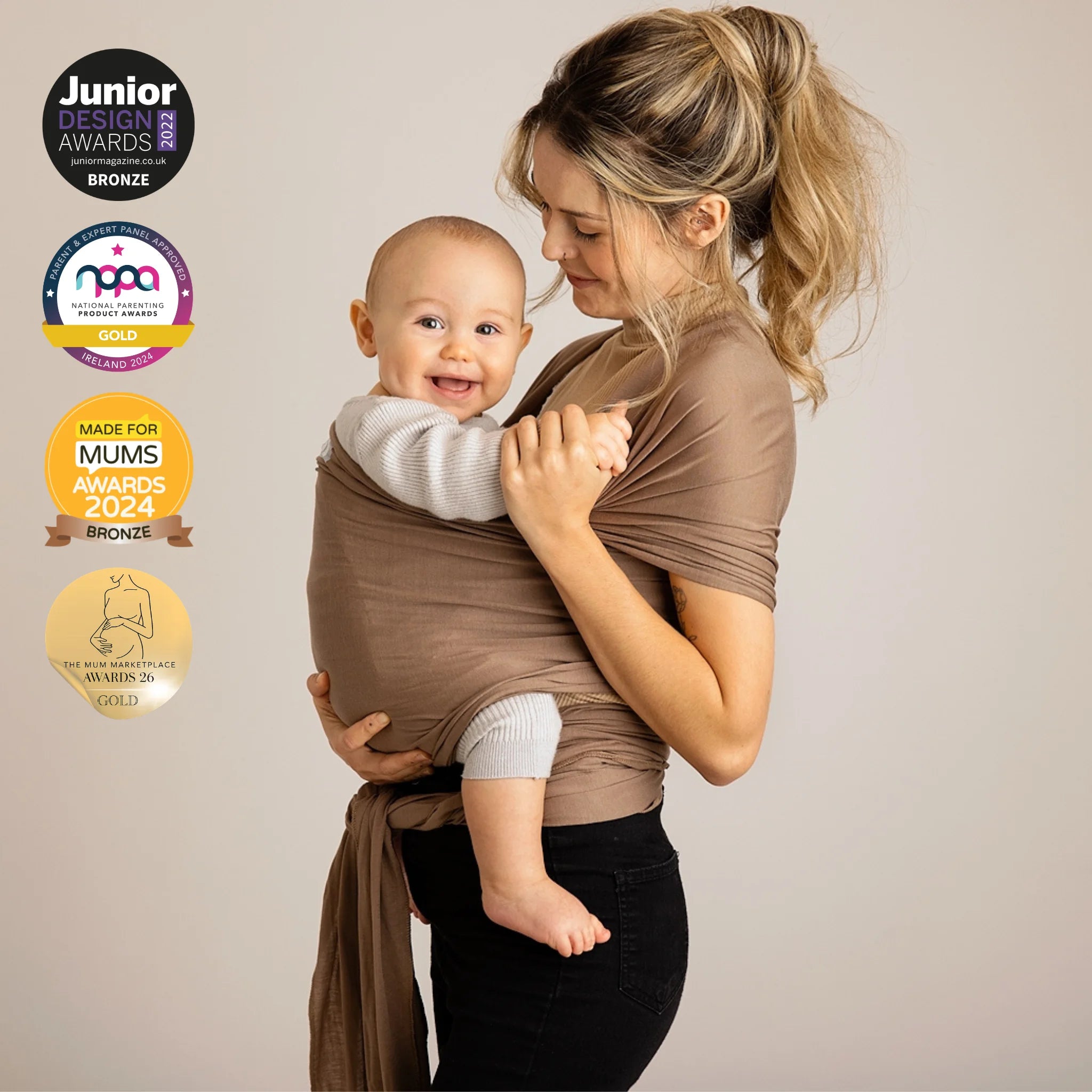 Mother carrying baby in Gaia Baby Nutmeg organic cotton stretchy baby wrap carrier, award-winning newborn baby sling