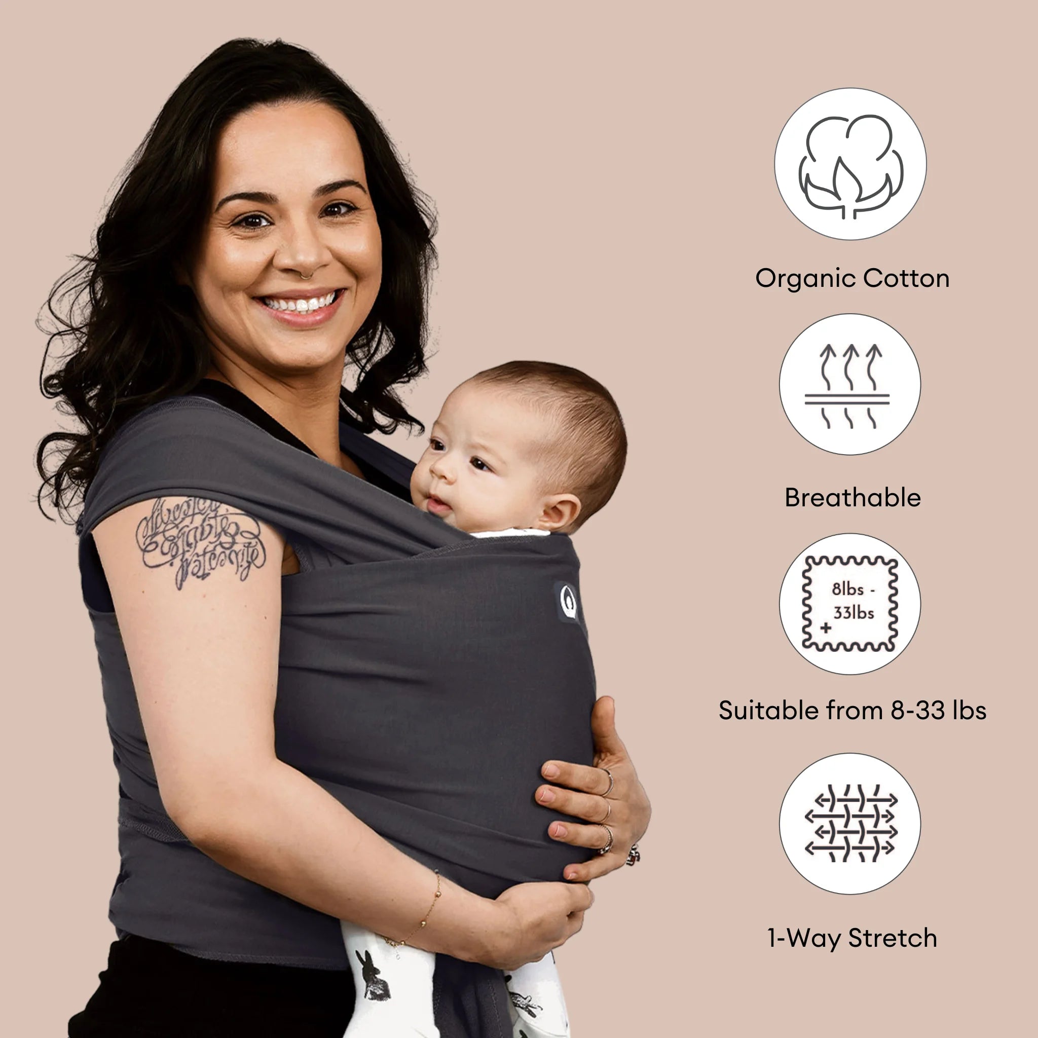 Woman holding a baby in a graphite stretchy wrap with organic cotton, breathable, and 1-way stretch features displayed
