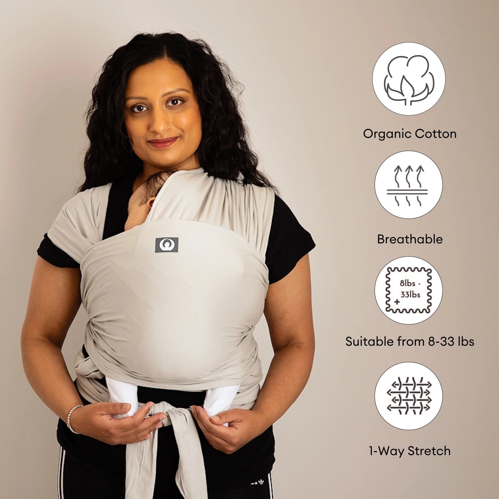 Mother wearing Gaia Baby stretchy wrap in silver grey highlighting organic cotton breathable features icons