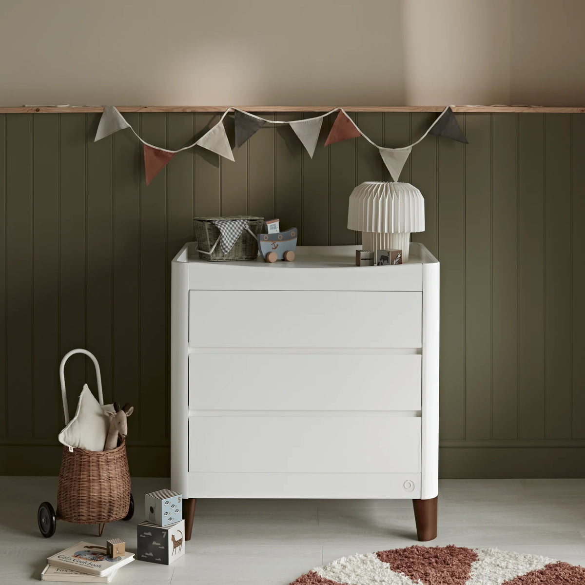 Gaia Baby Serena Dresser with walnut wood legs in a contemporary nursery, featuring spacious baby storage drawers, Scandinavian-inspired furniture design and stylish modern nursery décor.