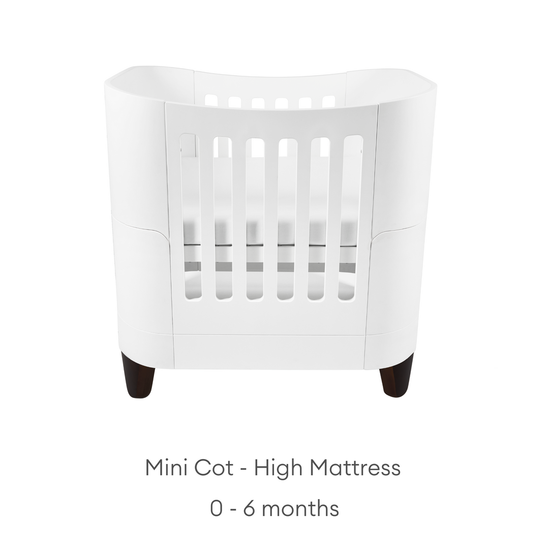 product image of Gaia baby Serena mini Cot with walnut legs showing the high mattress