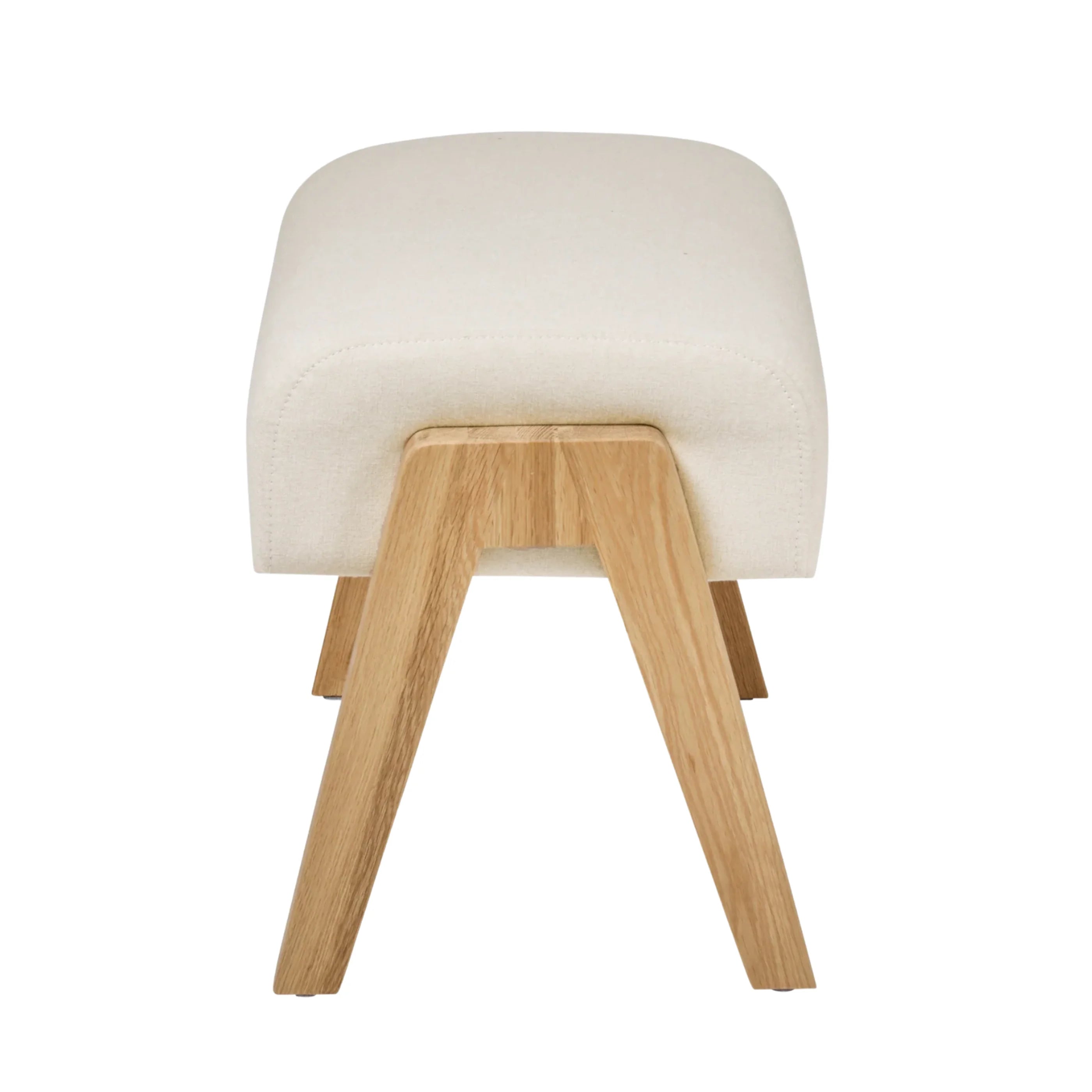 Hera Footstool Barley colour with wooden legs, back view of upholstered nursery footrest by Gaia Baby isolated on white.