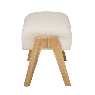 Hera Footstool Barley colour with wooden legs, back view of upholstered nursery footrest by Gaia Baby isolated on white.