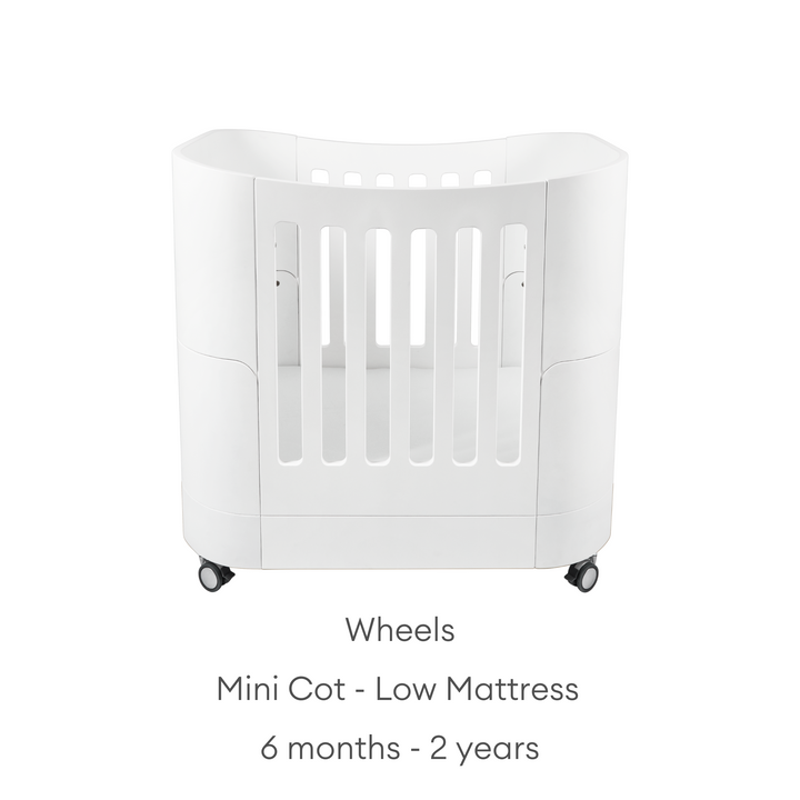 Gaia Baby Serena Mini Cot with Natural Legs - use low mattress from six months up to 2 years. Shown with wheels