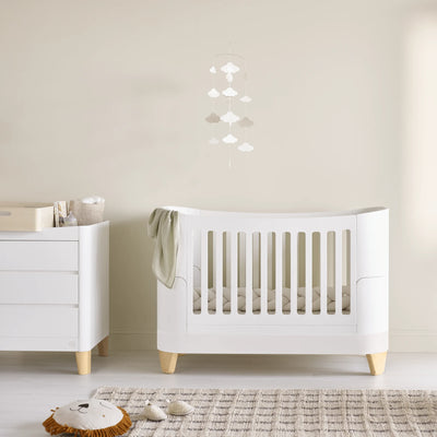 Minimalist nursery featuring the Gaia Baby Serena Cot Bed and Serena Dresser with natural wood legs, styled with the Hera Changing Station, soft neutral décor, and calming Scandinavian-inspired design.