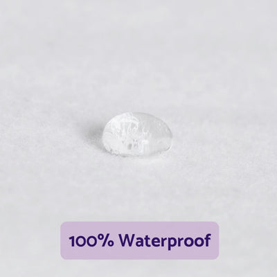 Water droplet beading on ClevaMama waterproof mattress protector fabric showing liquid resistance
