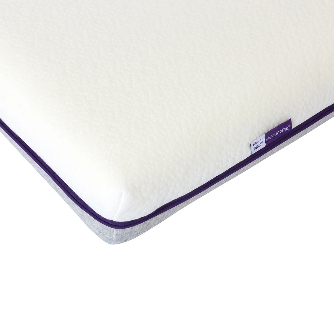 Close-up detail of ClevaMama ClevaFoam support cot mattress showing textured breathable cover and reinforced corner edge.