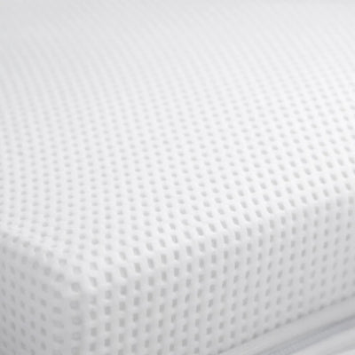 Close-up of Gaia Baby Dual Fibre cot bed mattress corner showing breathable fabric cover.