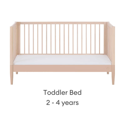 Gaia Baby EOS convertible cot bed in natural wood and powder blush converted to toddler bed stage