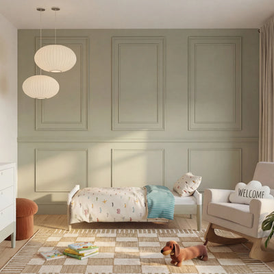 Gaia Baby EOS Convertible Cot in a sage green nursery with panelled walls, rug, pendant lights and wooden floor
