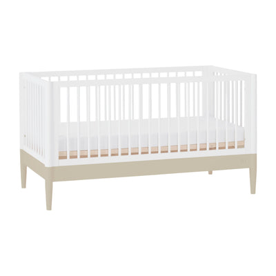 Gaia Baby EOS convertible cot bed in white and desert sage shown at an angled view.