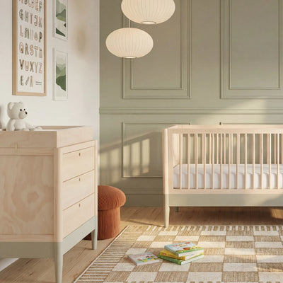 Modern nursery room featuring Gaia Baby EOS natural wood baby dresser with changing station