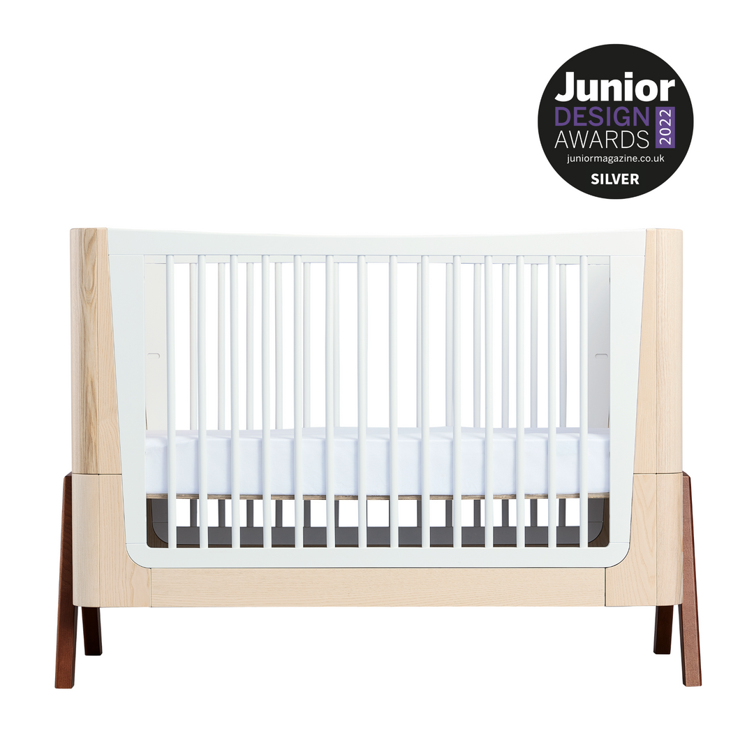This is a product image of the Hera Convertible Cot Bed from Gaia Baby on a white background with the Junior Design Awards 2022 Silver Award Logo in the top right corner.