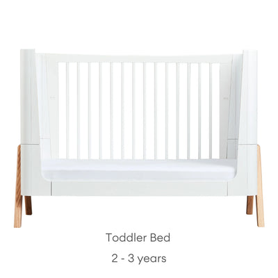 Front view of Gaia Baby Hera Cot Bed in scandi white, converted into Toddler Bed mode, with one side removed. Text reads: Toddler Bed suitable from 2 to 3 years.