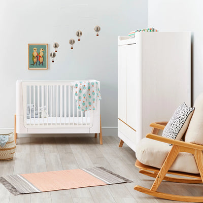 Hera Cot Bed Scandi White with matching wardrobe and rocking chair in a modern styled nursery.