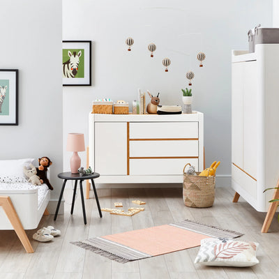 Hera Dresser with matching wardrobe and Hera Cot Bed in first bed mode styled in realistic nursery.