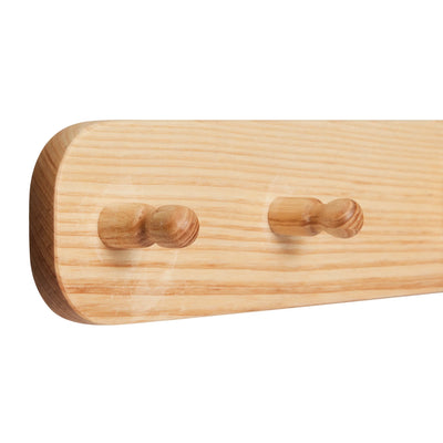 The ash wood Hera hanging peg rail viewed from a 45 degree angle zoomed in on the end with 2 pegs visible.