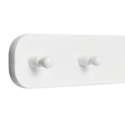 The white Hera hanging peg rail viewed from a 45 degree angle zoomed in on the end with 2 pegs visible.