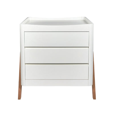 Front view of a white Gaia Baby Hera dresser with three drawers and natural wooden legs, isolated on a white background.