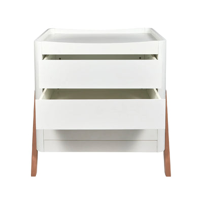 Front view of the Gaia Baby Hera dresser in a white and natural oak finish, featuring two spacious drawers partially open to showcase storage capacity, with a built-in changing top and angled wooden legs on a white background.